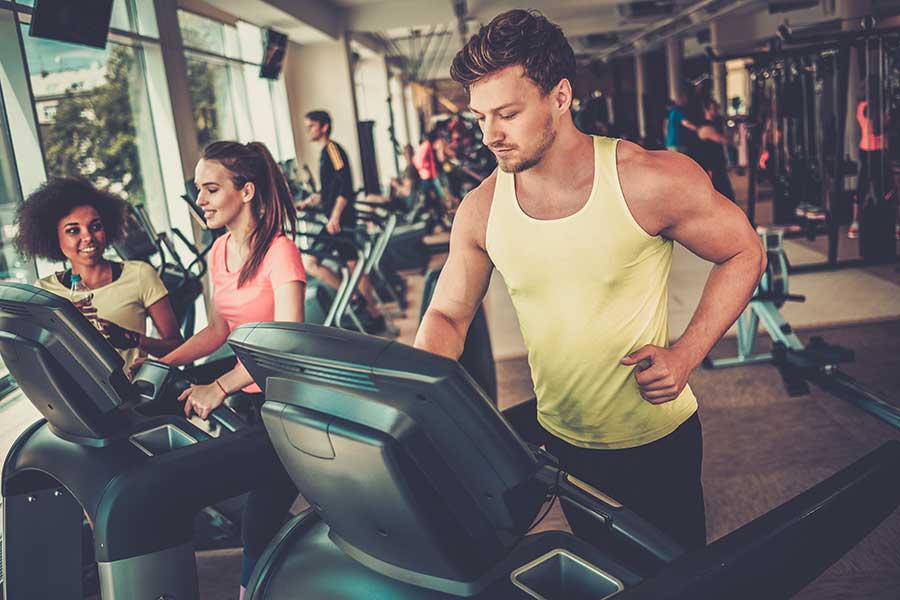 Man running on a treadmill in a gym