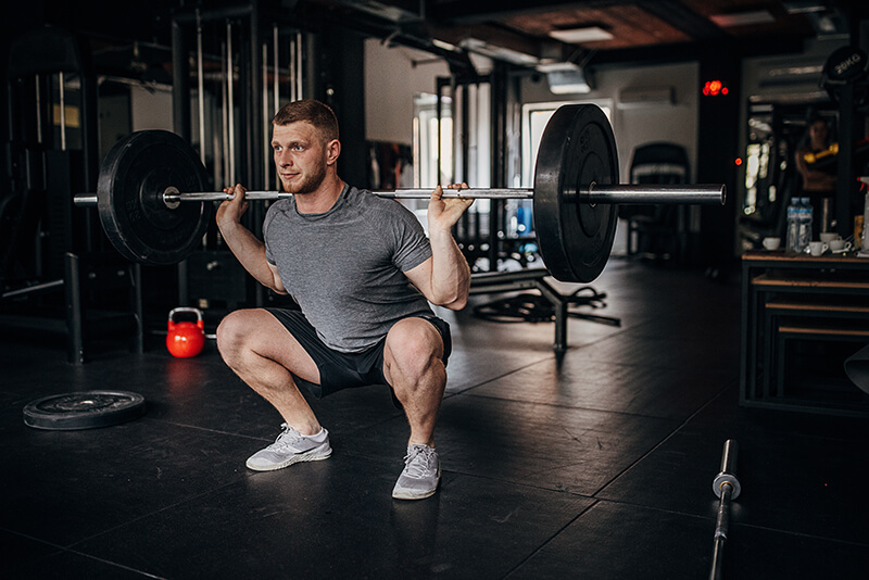 Man lifting weight to achieve new milestones through mobility exercises