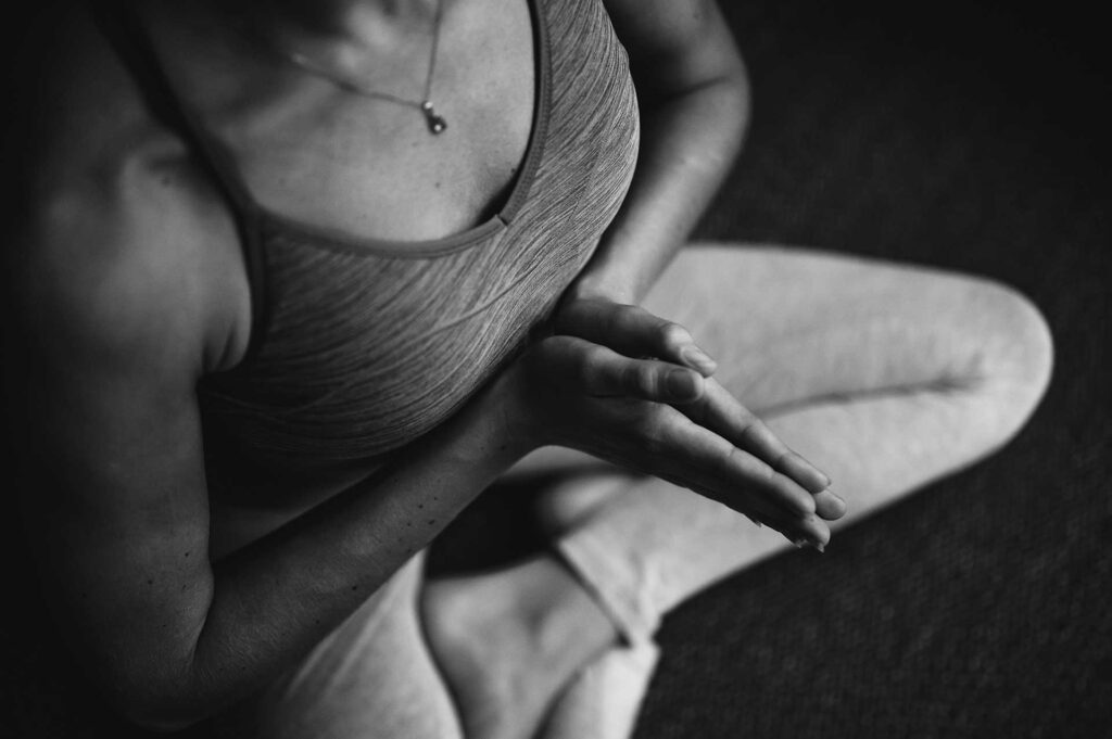 Overhead shot of a woman in Coquitlam practicing yoga at Gold’s Gym, demonstrating a serene pose on her mat.